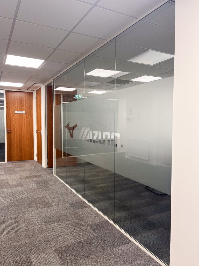 outside of glass meeting room with Mizuno manifestation on glass. 