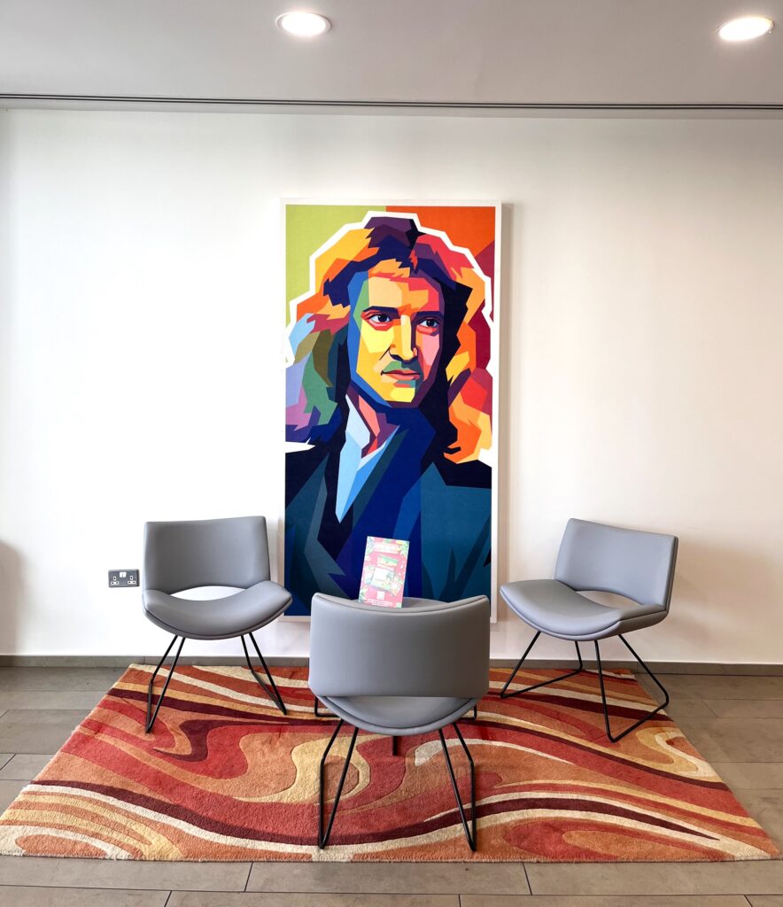 three chairs on top of a rug next to a modernist piece of art