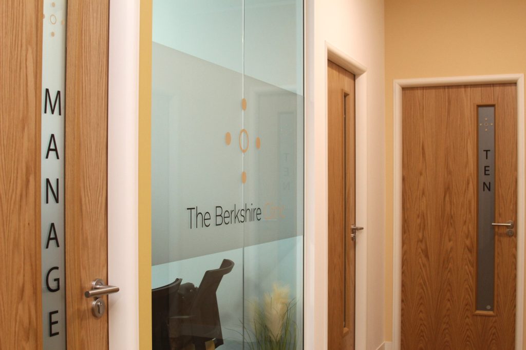 corridor outside of glass walled meeting room