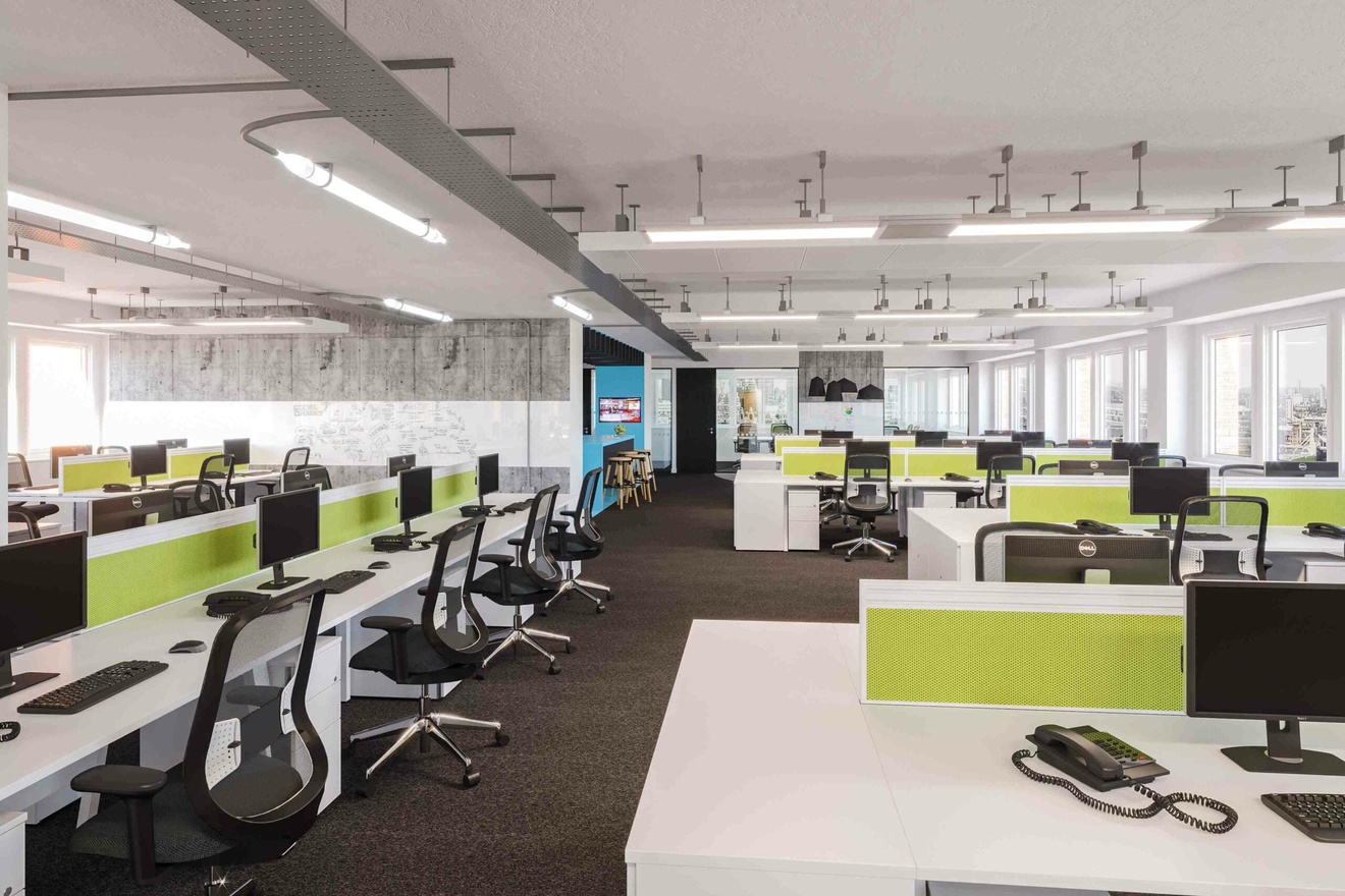 An office filled with multiple desks and work stations.