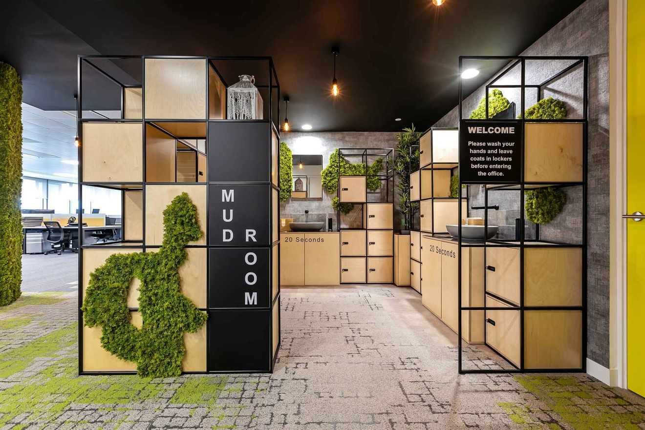 A handwashing station with lockers, sinks and shelving.