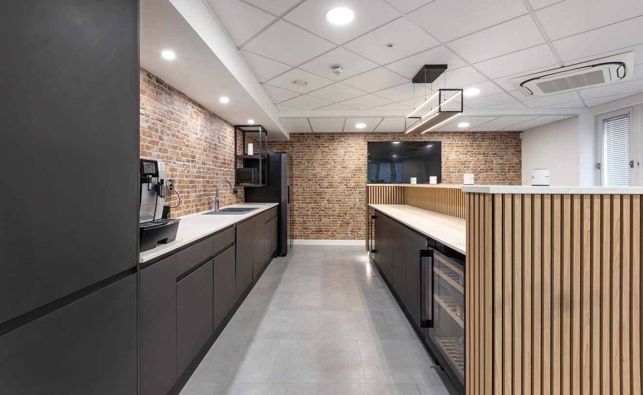 modern minimalist black kitchen with exposed red brick walls