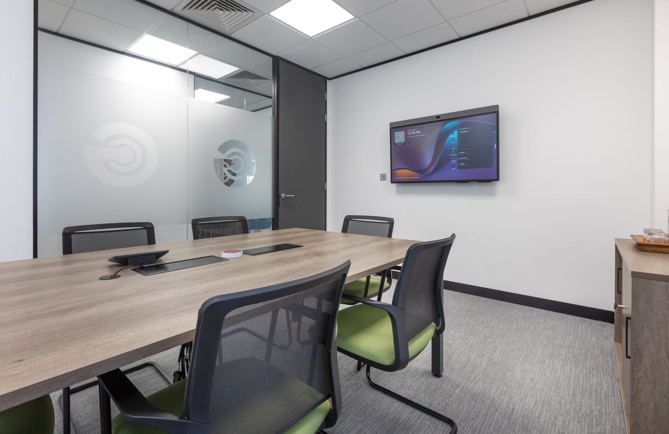 office board room with flat screen tv and green office chairs