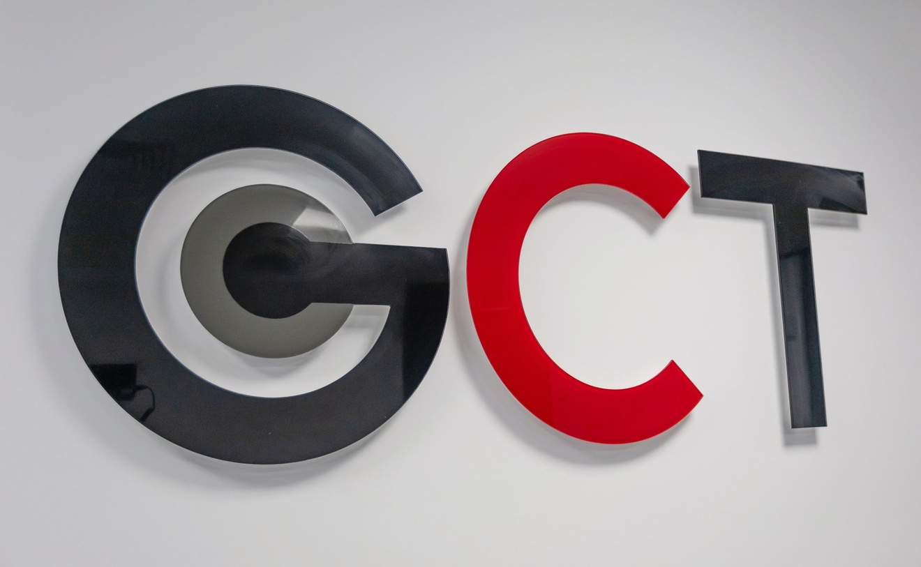 GCT logo mounted on a white wall