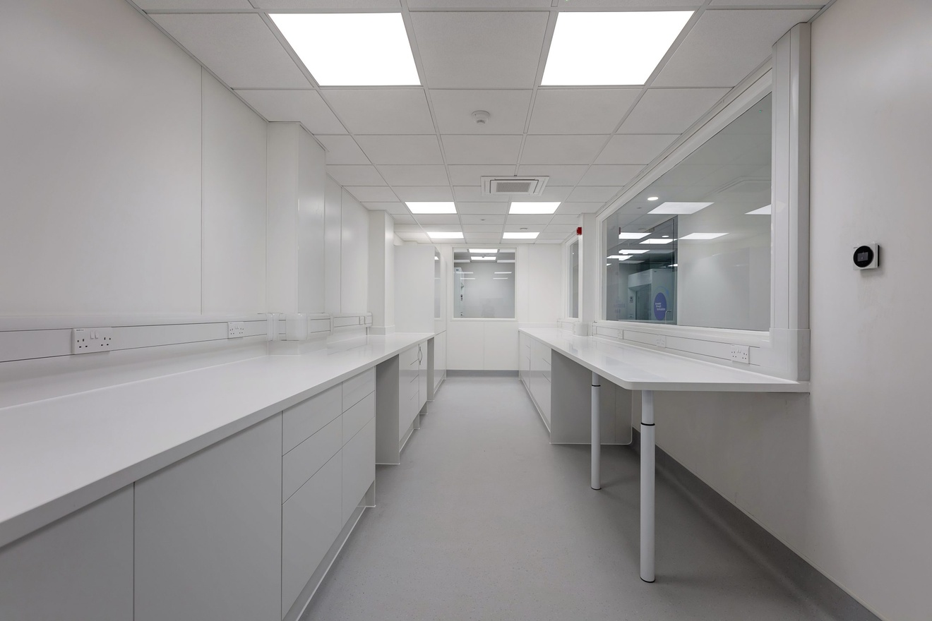 completely white room with a countertop to the right and drawers and cupboards to the left