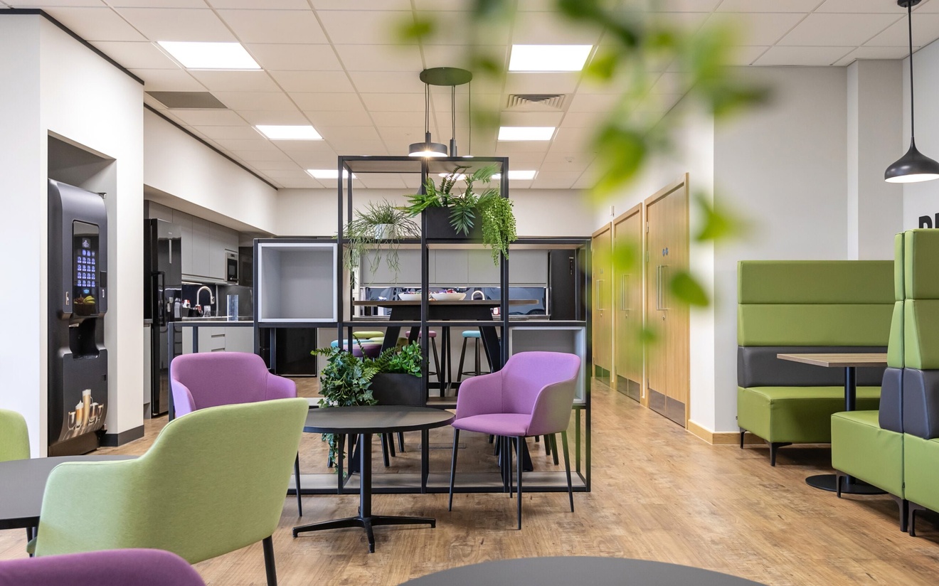 break room with sitting areas, coffee vending machine and kitchen area