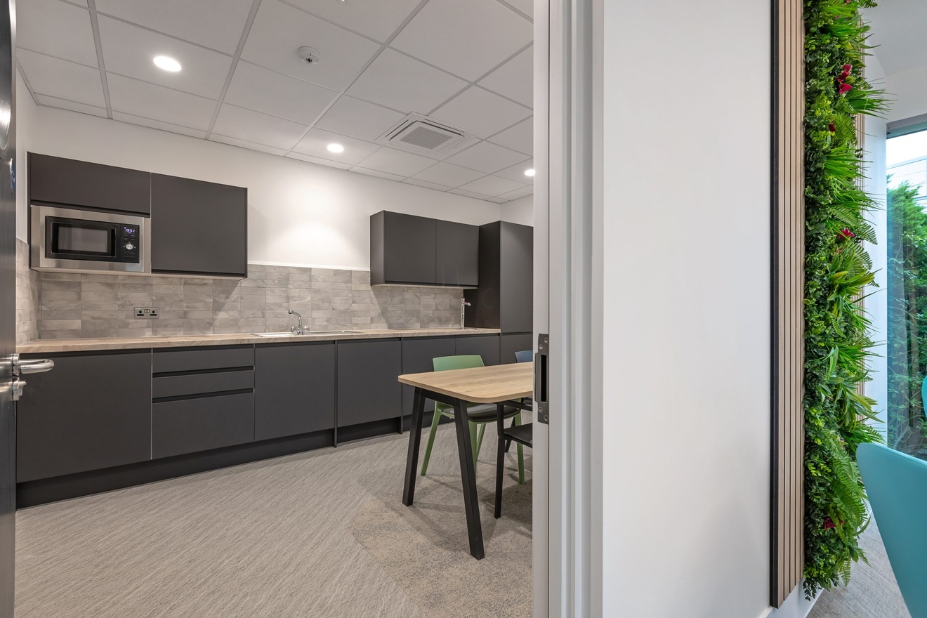 black and white minimalist kitchen with black drawers and cupboards