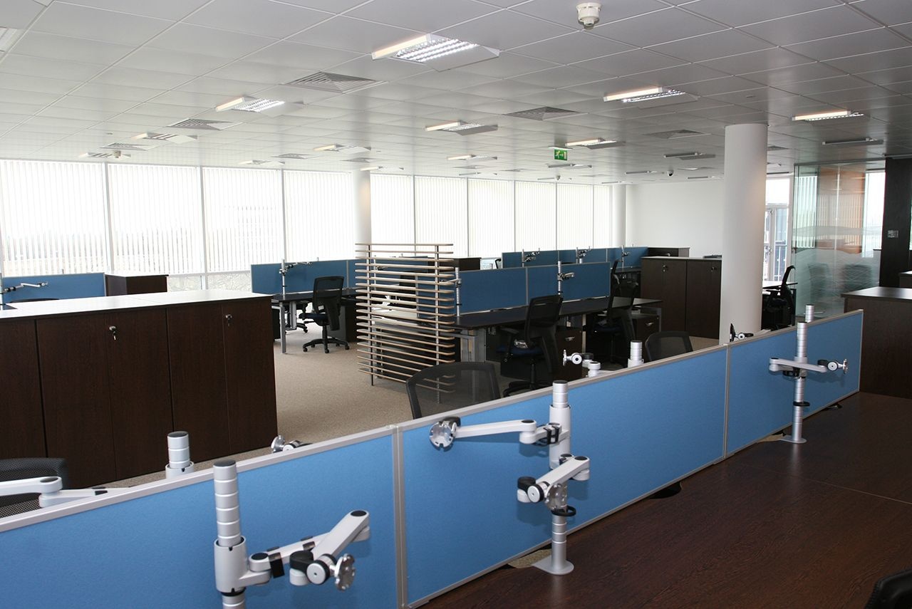 An empty office, with desks and chairs.