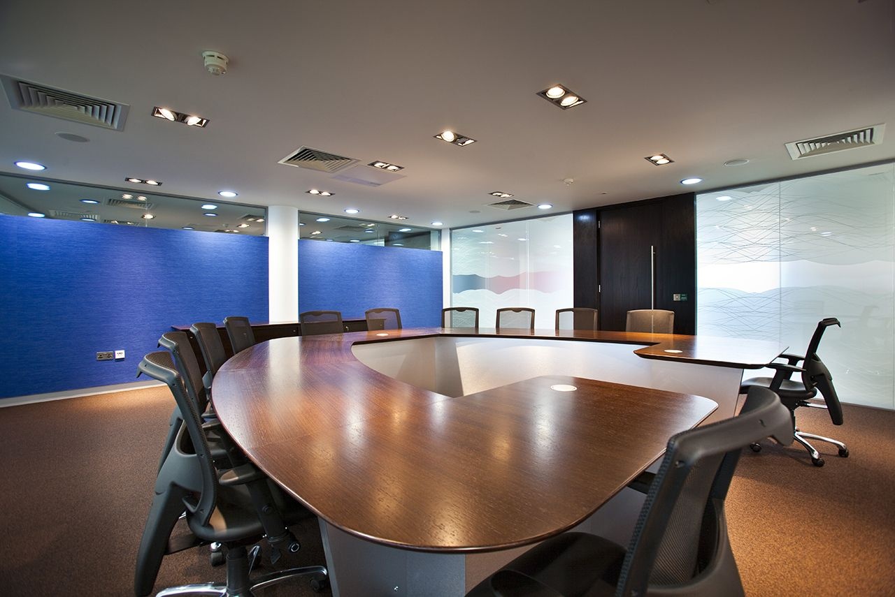 A custom boardroom table with chairs going around in a curve.