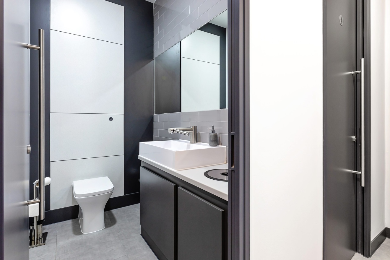 modern minimalist bathroom with grey doors and white and grey walls