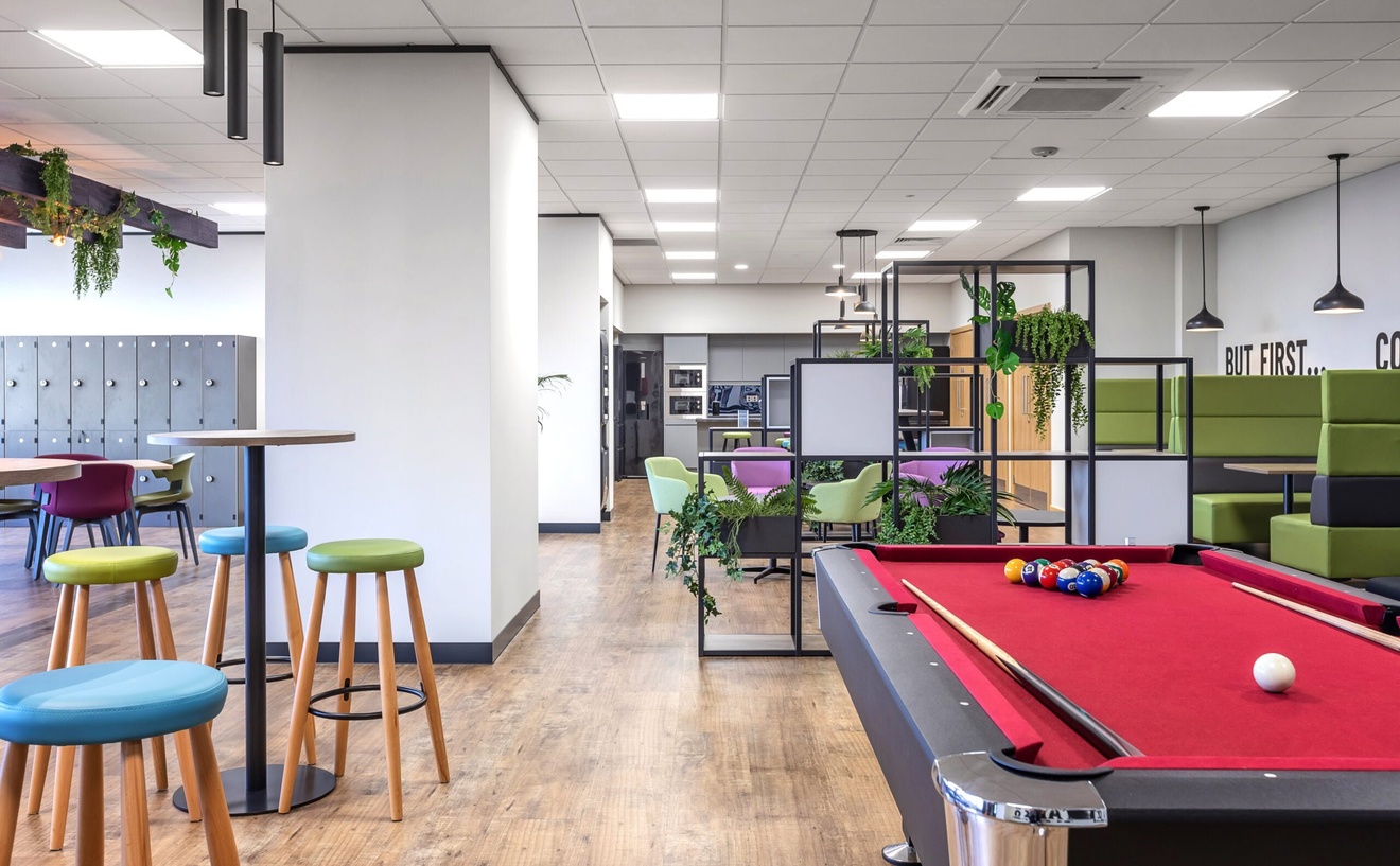 office breakout area with pool table, kitchen and seating areas