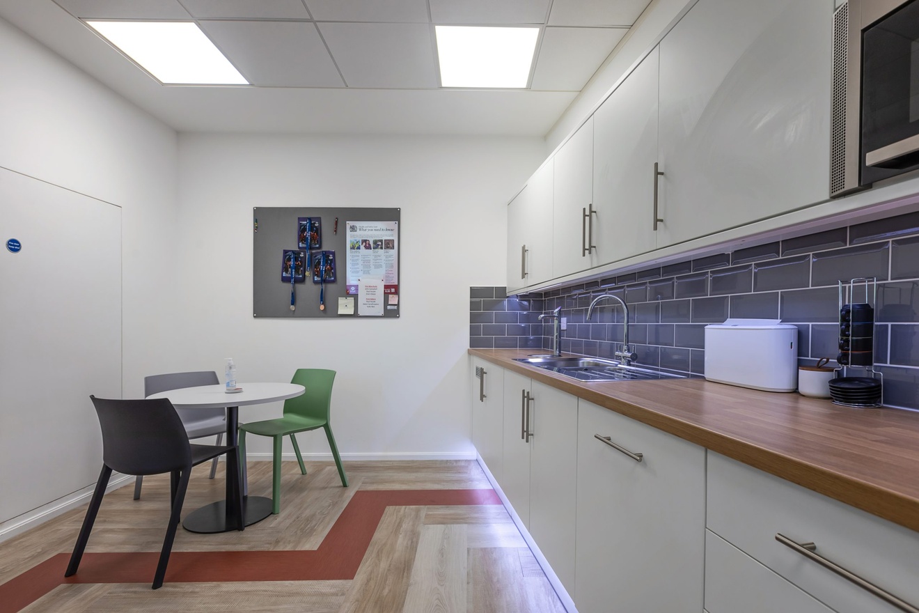 kitchen area with three chairs at a dining table