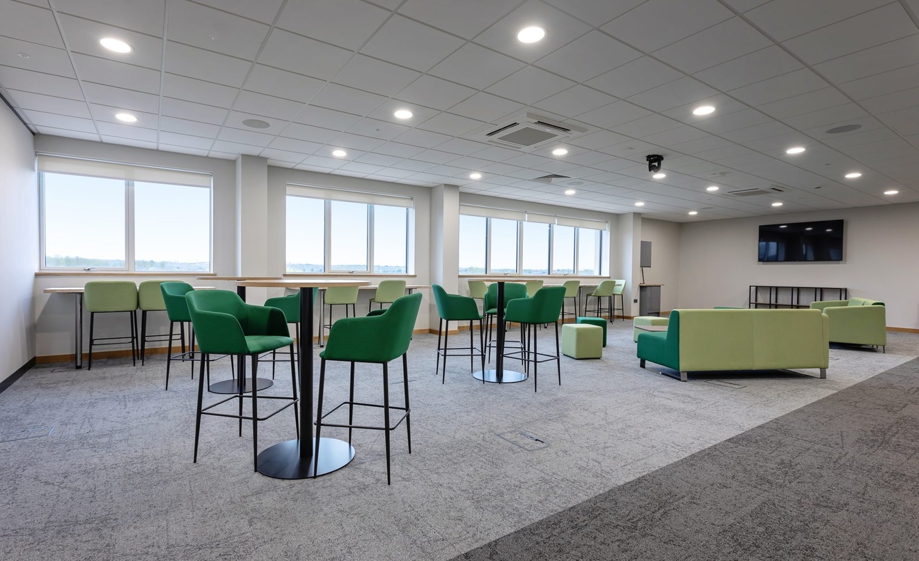 open plan breakout space with green furniture throughout