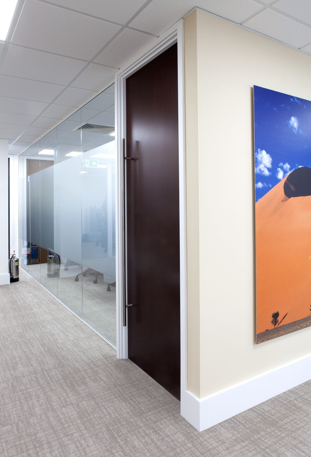A hallway with a glass partitioning wall.
