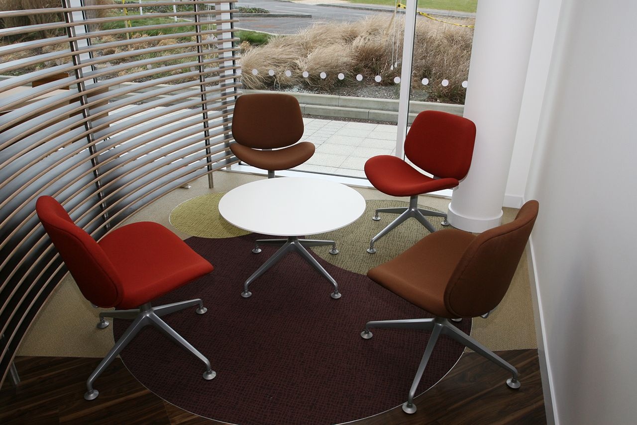 Four chairs around a small coffee table.