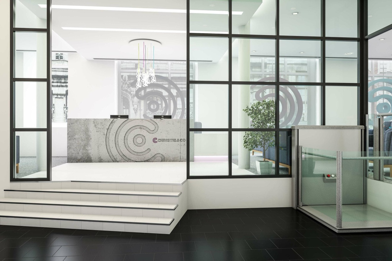 A reception area with stairs going up to the front desk.