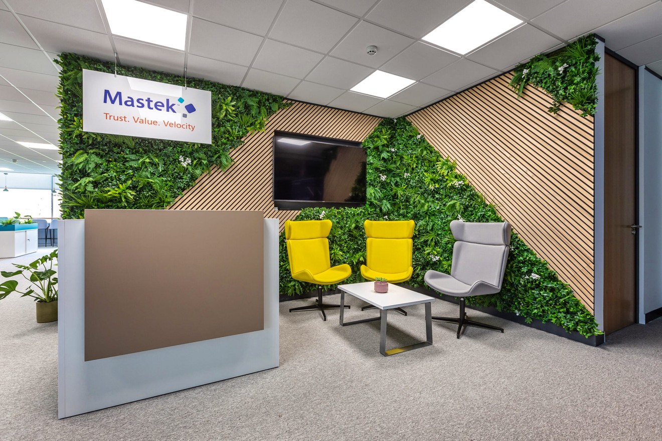 Picture of Reception area with yellow and grey chairs and a reception desk.