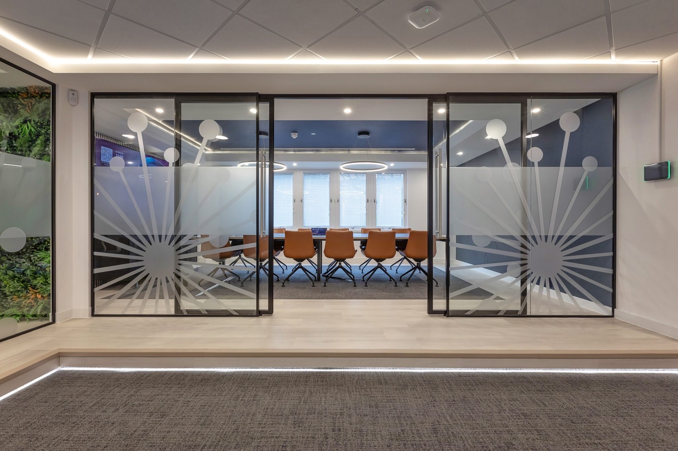 open glass sliding doors leading to office meeting room