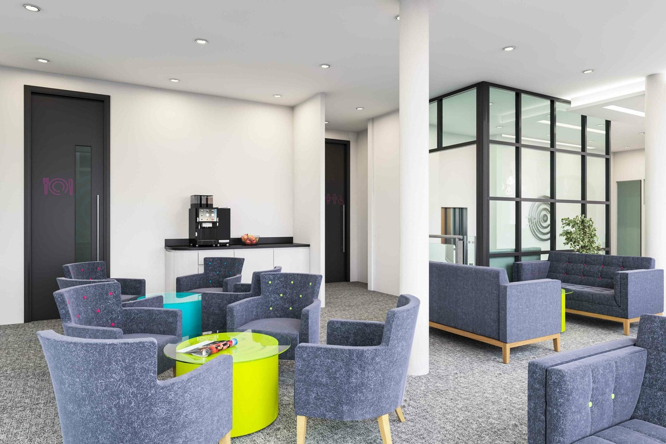 An office breakout space with sofas, armchairs and coffee tables.