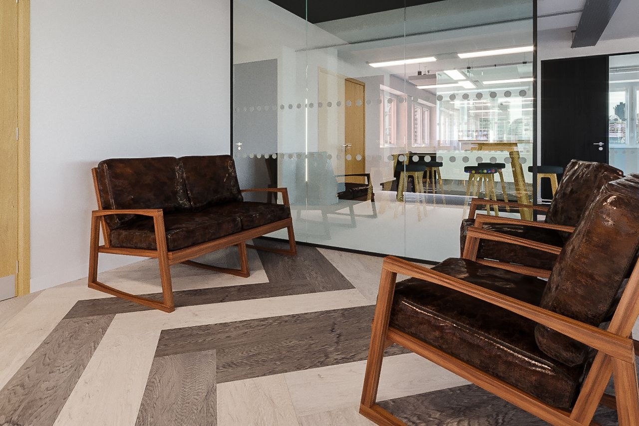 A double sofa and two brown wooden armchairs opposite each other.