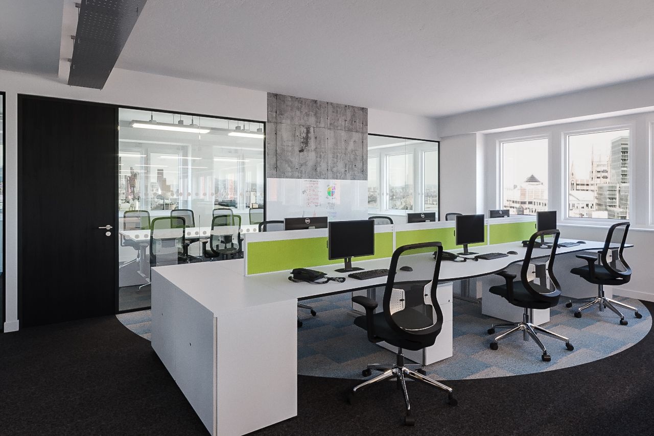 A desk with computer screens, keyboards and telephones on the top of it with office chairs tucked under it.
