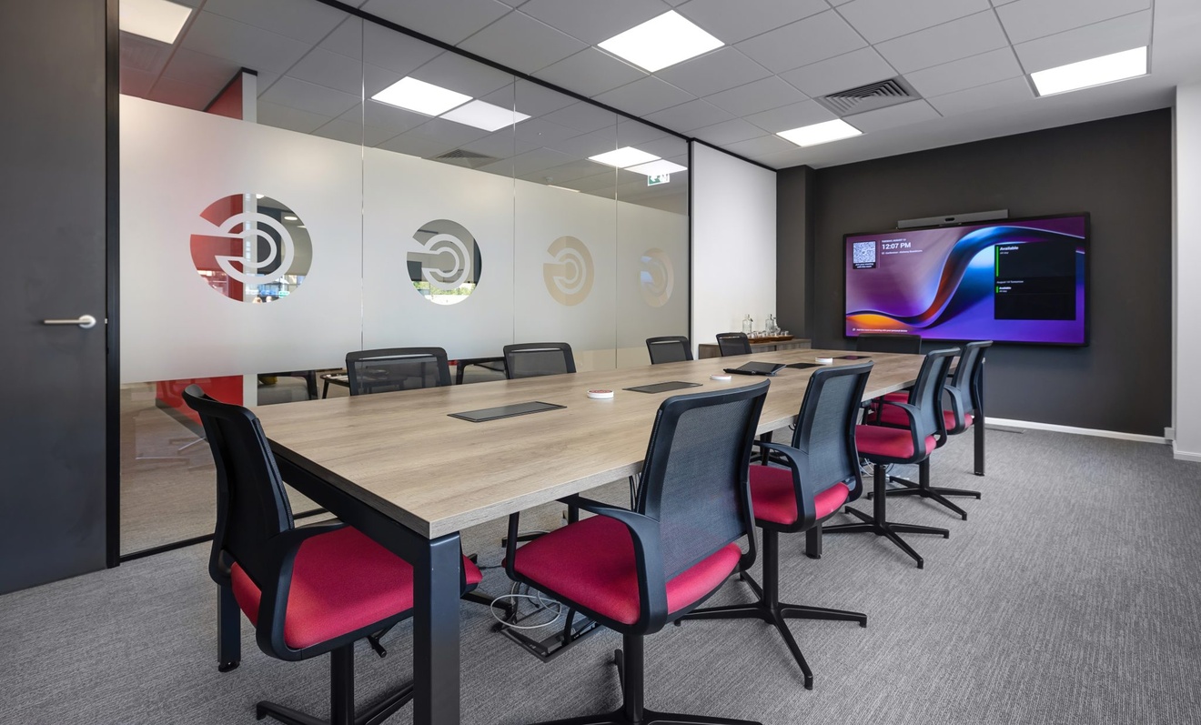 office meeting room with tv and red chairs