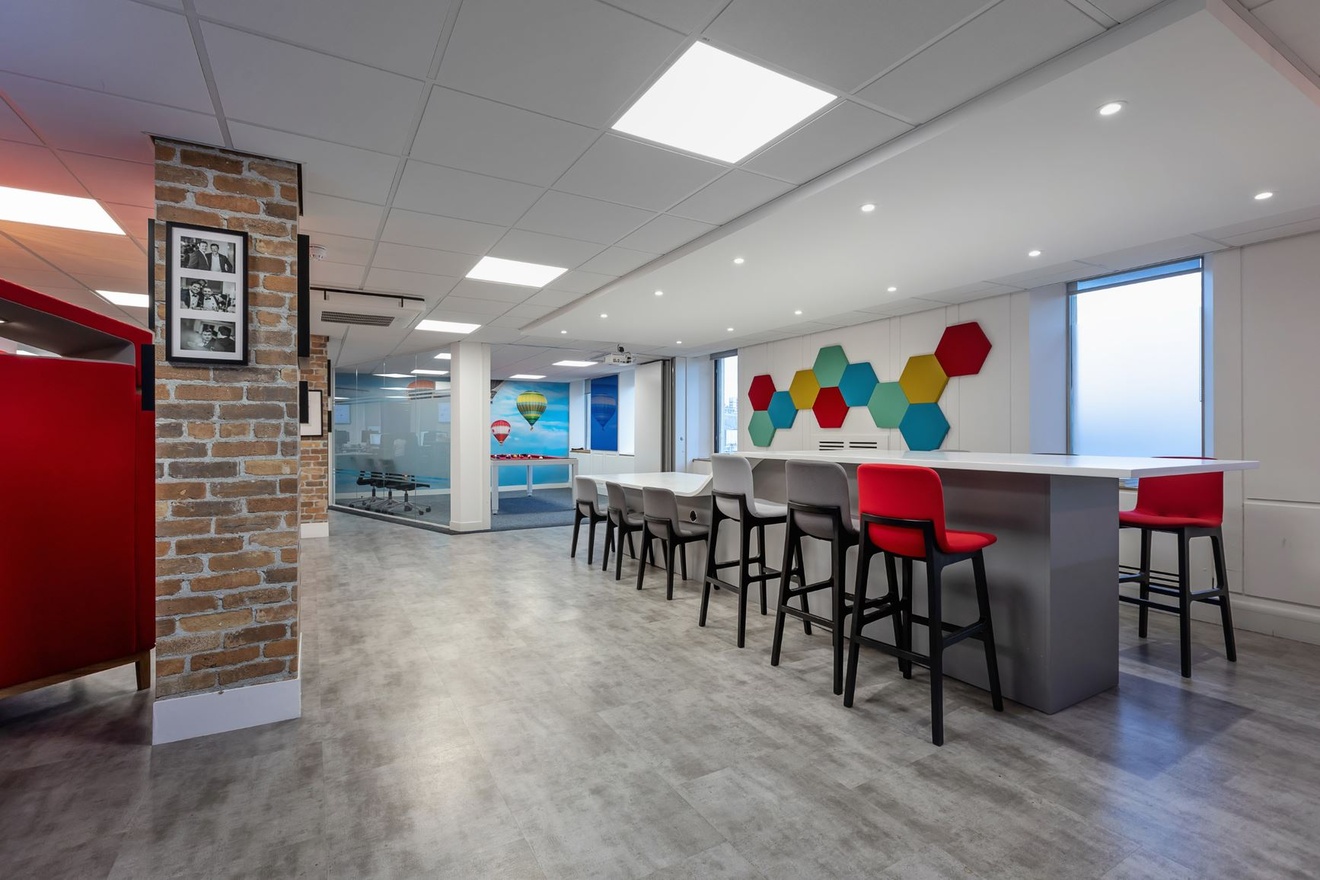 A table with two differing levels with adequate chairs or stools along the outside.