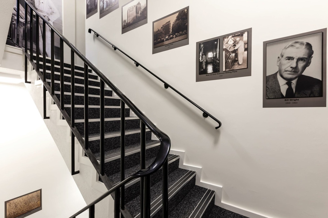 A staircase with multiple images on the wall.